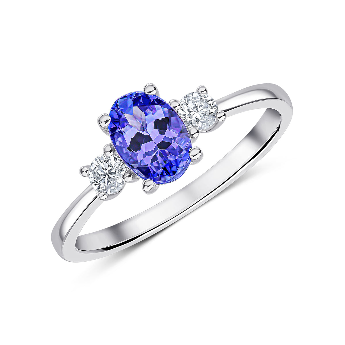18CT WG 7X5 OVAL TANZANITE AND ROUND DIAMOND CLAW SET 3ST RING