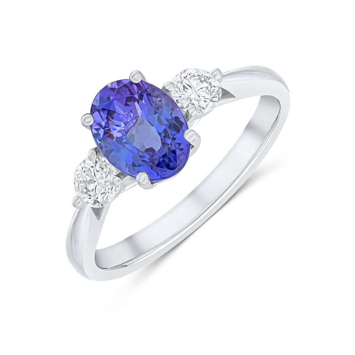 18CT WG 8X6 OVAL TANZANITE AND ROUND DIAMOND CLAW SET 3ST RING