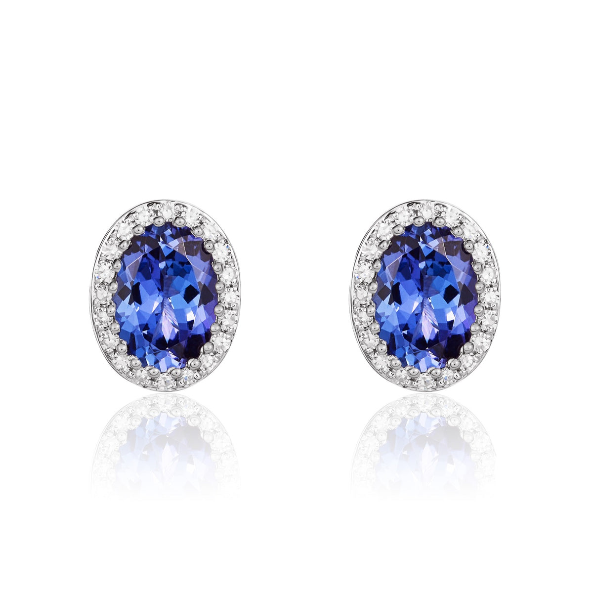 9CT WHITE GOLD OVAL TANZANITE AND ROUND DIAMOND CLAW CLUSTER EARRINGS