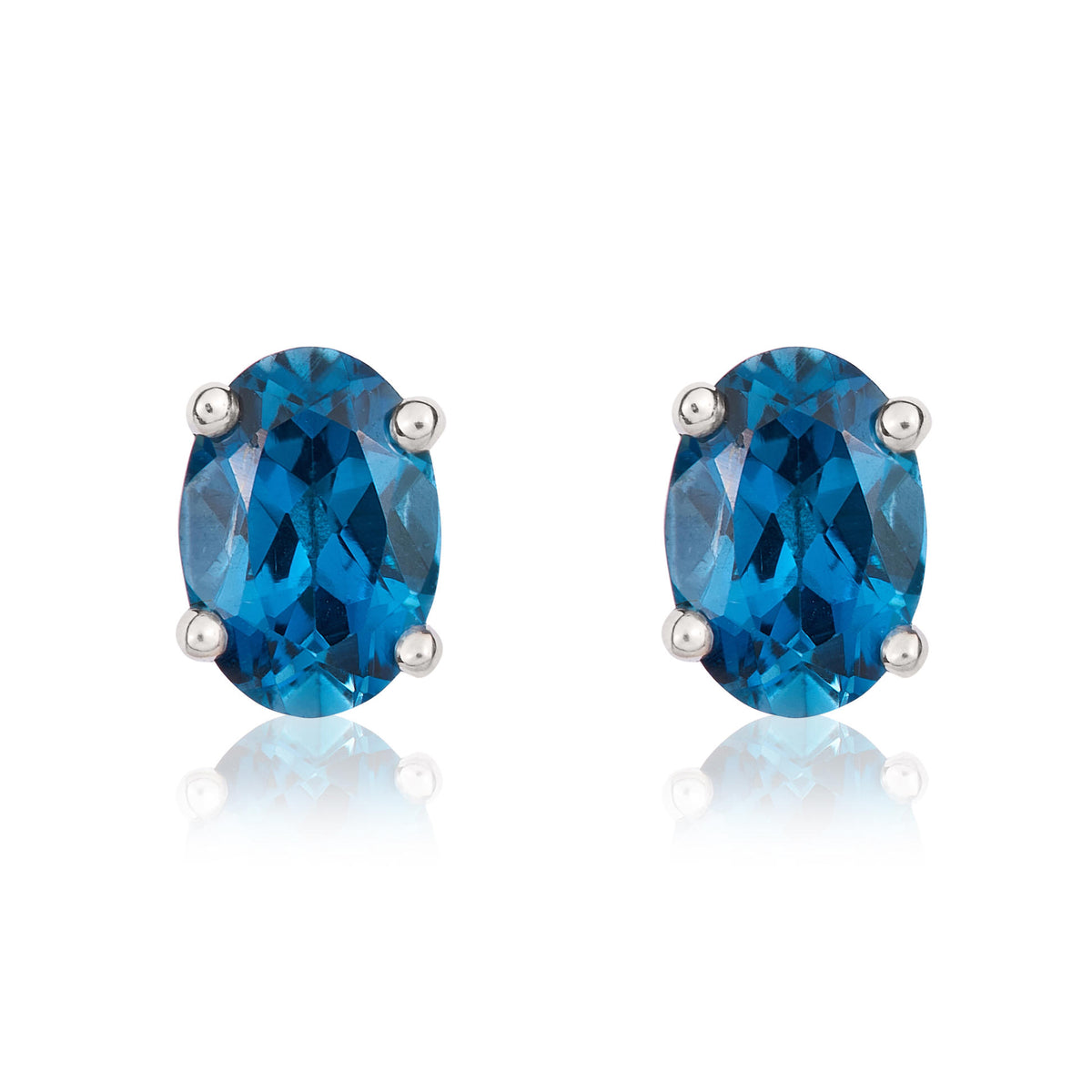 9CT WG 7X5 OVAL LONDON BLUE TOPAZ CLAW STUD EARRINGS